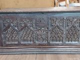 a wooden chest sitting on a hard wood floor