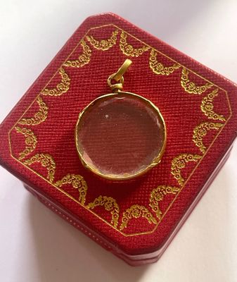 a small red box with a gold ring on it
