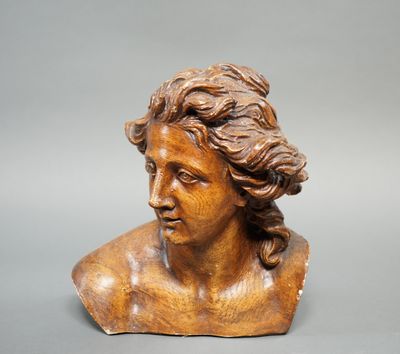 a close up of a wooden bust of a woman with long hair