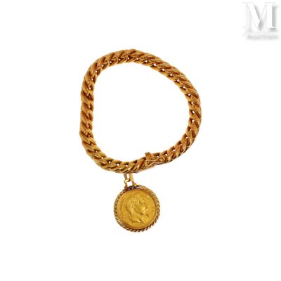 a close up of a gold chain bracelet with a coin on it