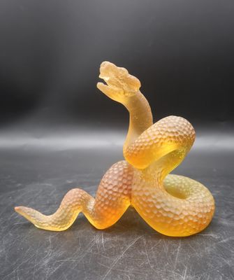 a yellow snake that is laying down on a table