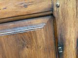 a close up of a wooden cabinet with a door handle