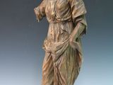 bronze statue of a woman holding a flower in her right hand