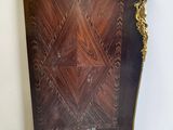 an image of a wooden cabinet with a decorative design on the front