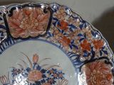 a plate with a flower design on it on a table