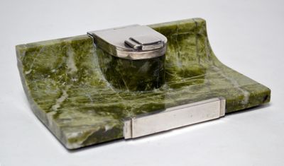 a green marble sink with a metal faucet on it