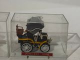a small toy car in a clear box on a table
