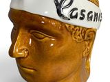 a ceramic head of a man with a bandana on his head