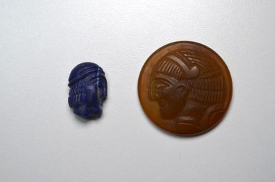 an image of a coin and a blue scarra on a white surface
