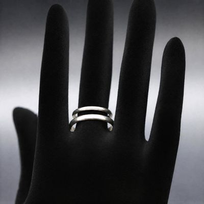 a close up of a person ' s hand with a ring on it