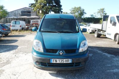 a blue van parked in a parking lot next to other cars