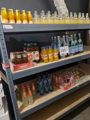 a lot of bottles and cans on the shelves