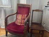 a red chair and a brown chair in a living room