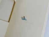 an open book with a drawing of a boy in a blue shirt