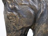 a statue of a horse that is standing on a table