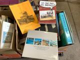 many books that are in a box on the floor