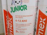 bottles of junior toothpaste sitting on a shelf in a store