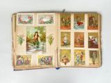 an open book with pictures of people and animals on it