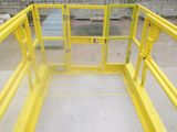 a yellow gate that is open to let people inside