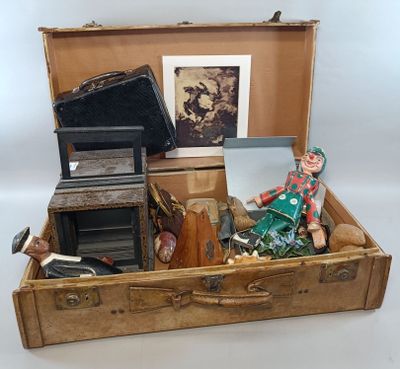 a suitcase with a doll inside of it on a table