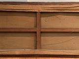 an old wooden shelf with a glass door on it