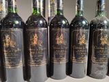 several bottles of wine are lined up on a table