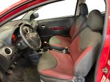 the interior of a red car with red seats and a steering wheel