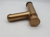 a close up of a brass pipe on a white surface