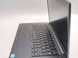 a laptop that is open on a white table