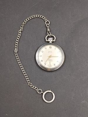 a silver pocket watch with a chain attached to it