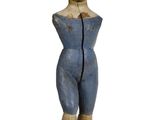 a small wooden statue of a boy standing on a pedestal