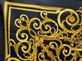 a black and gold scarf with a gold design on it