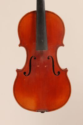 an old violin with a bow hanging from it ' s back