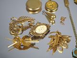 many different types of gold jewelry on a table