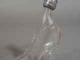 a glass shoe with a bottle on the side of it