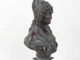 an antique bronze bust of a woman with a helmet on her head