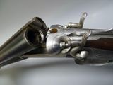an old gun with a wooden handle on a white background