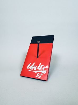 a red and black bag with a white logo on it