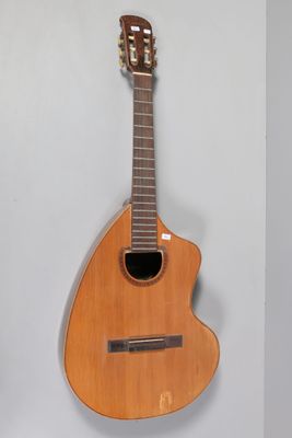 a guitar hanging on the wall next to a wall