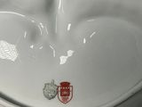 a white toilet with a red and white sticker on it