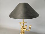 a lamp that is sitting on a table with a lamp shade on it