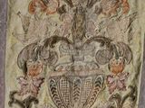 an old piece of cloth with a design of a vase on it