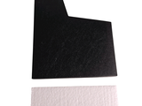 a picture of a piece of black paper and a piece of white paper on a white surface