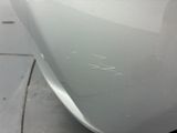 a close up of a car ' s front bumper with scratches on it