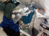a pile of clothes and other items in a plastic bag