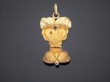 a gold charm with a heart and a flower on it