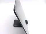 a close up of a laptop on a stand on a white surface