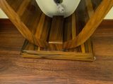 a toilet that is sitting on a wooden stand