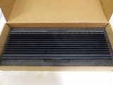 an open cardboard box with a black grill in it on a white surface