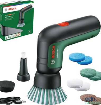 a close up of a green and black electric polisher with a box
